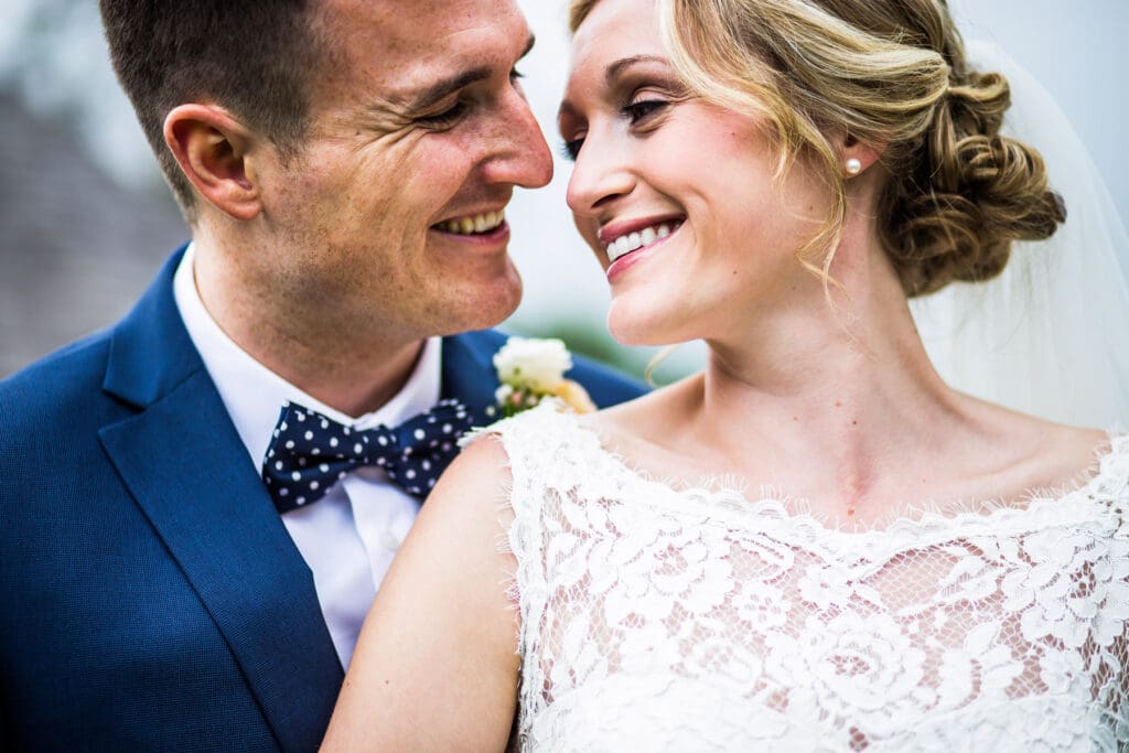 Bride and groom sharing a smile during their wedding day at The Gardens wedding venue in Kent, photographed by The Gardens wedding photographer.